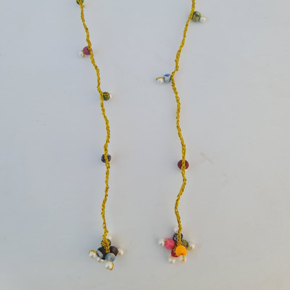 Long necklace with colorful beads on a light gray background