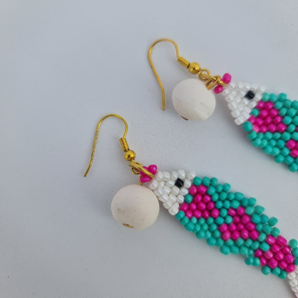 Beaded earrings with colorful patterns on a light gray background