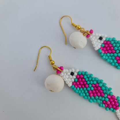 Beaded earrings with colorful patterns on a light gray background