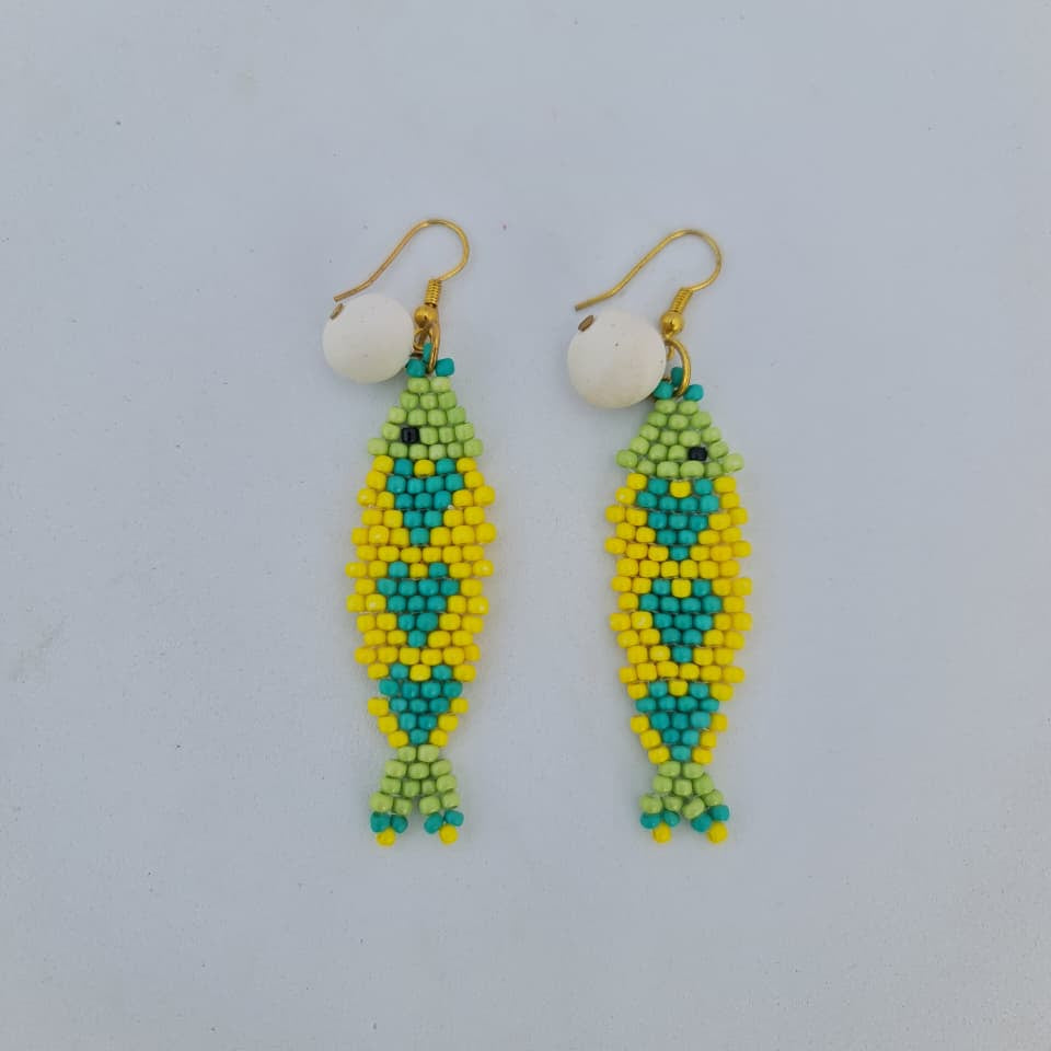 Beaded earrings with green and yellow pattern on a light gray background