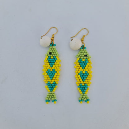 Beaded earrings with green and yellow pattern on a light gray background