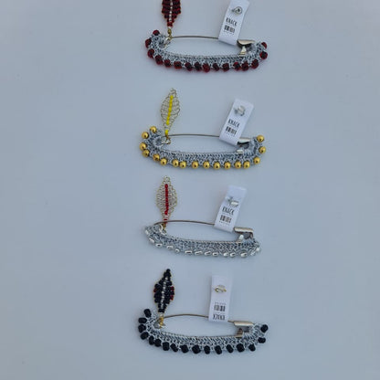 Set of brooches with tags on a light gray background