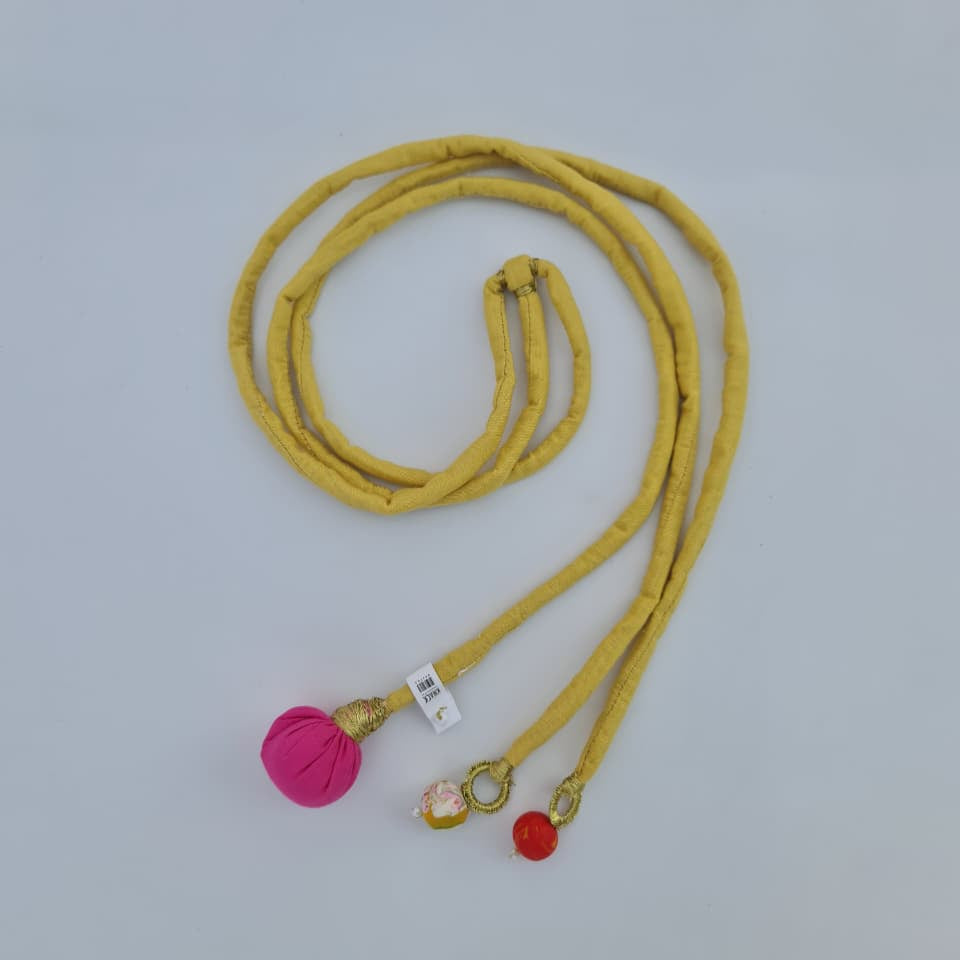 Yellow cord with decorative pendants on a light gray background