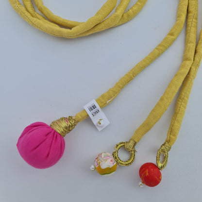 Yellow cord with colorful beads on a white background